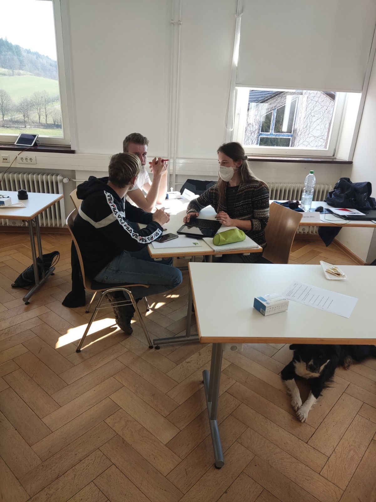 Arbeiten mit dem IPad Drei Schülerinnen und Schüler, die gemeinsam am IPad arbeiten.